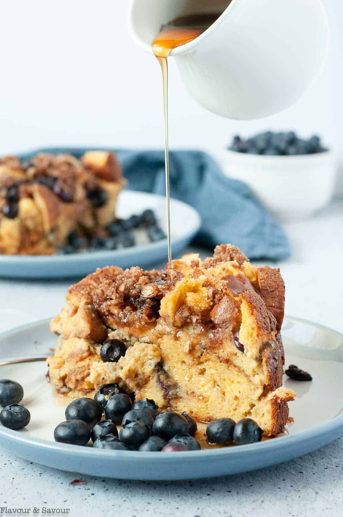 Drizzling maple syrup on Blueberry French Toast Casserole