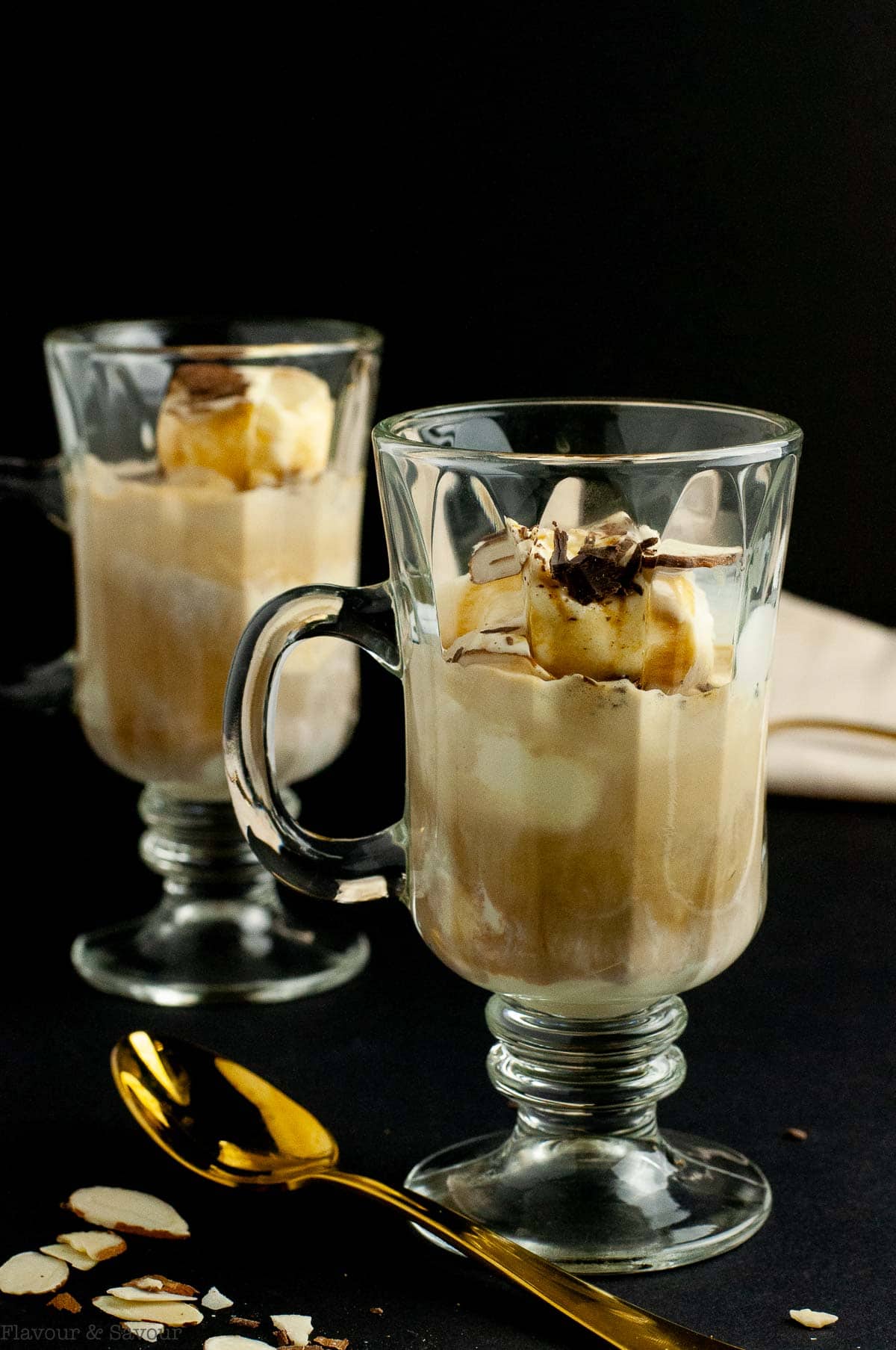 Two glasses of affogato coffee with a spoon.