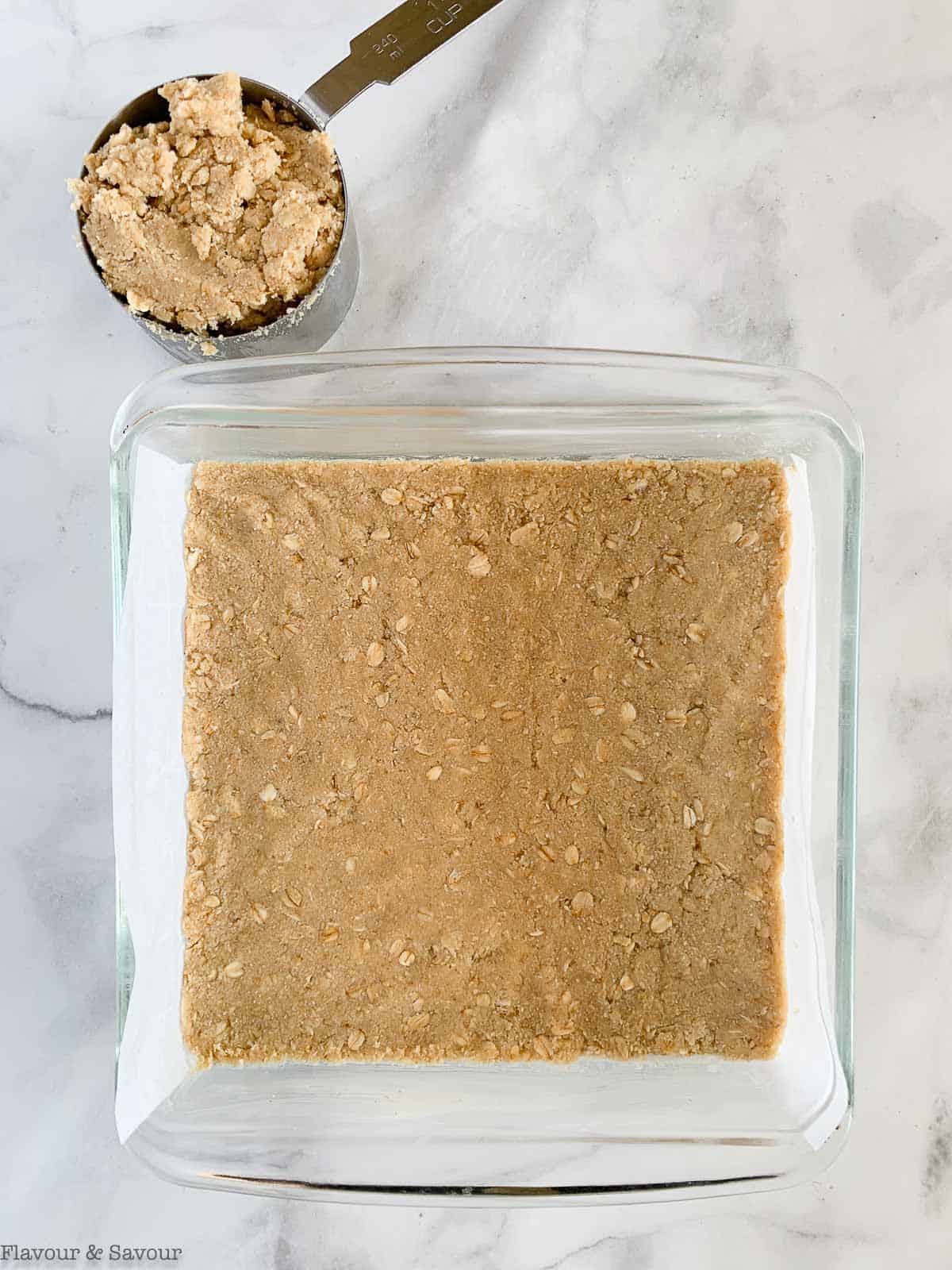 Shortbread base pressed into baking pan.