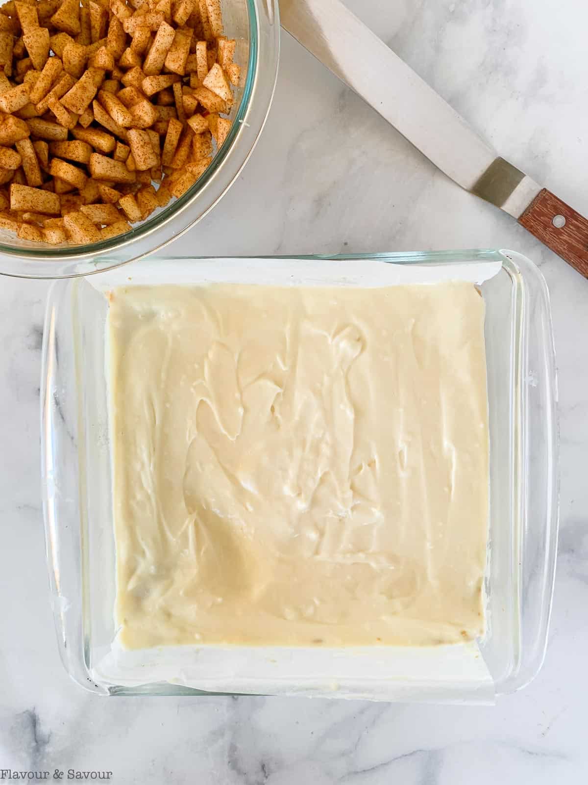 Cheesecake filling spread on a shortbread base to make apple cheesecake crumble bars.