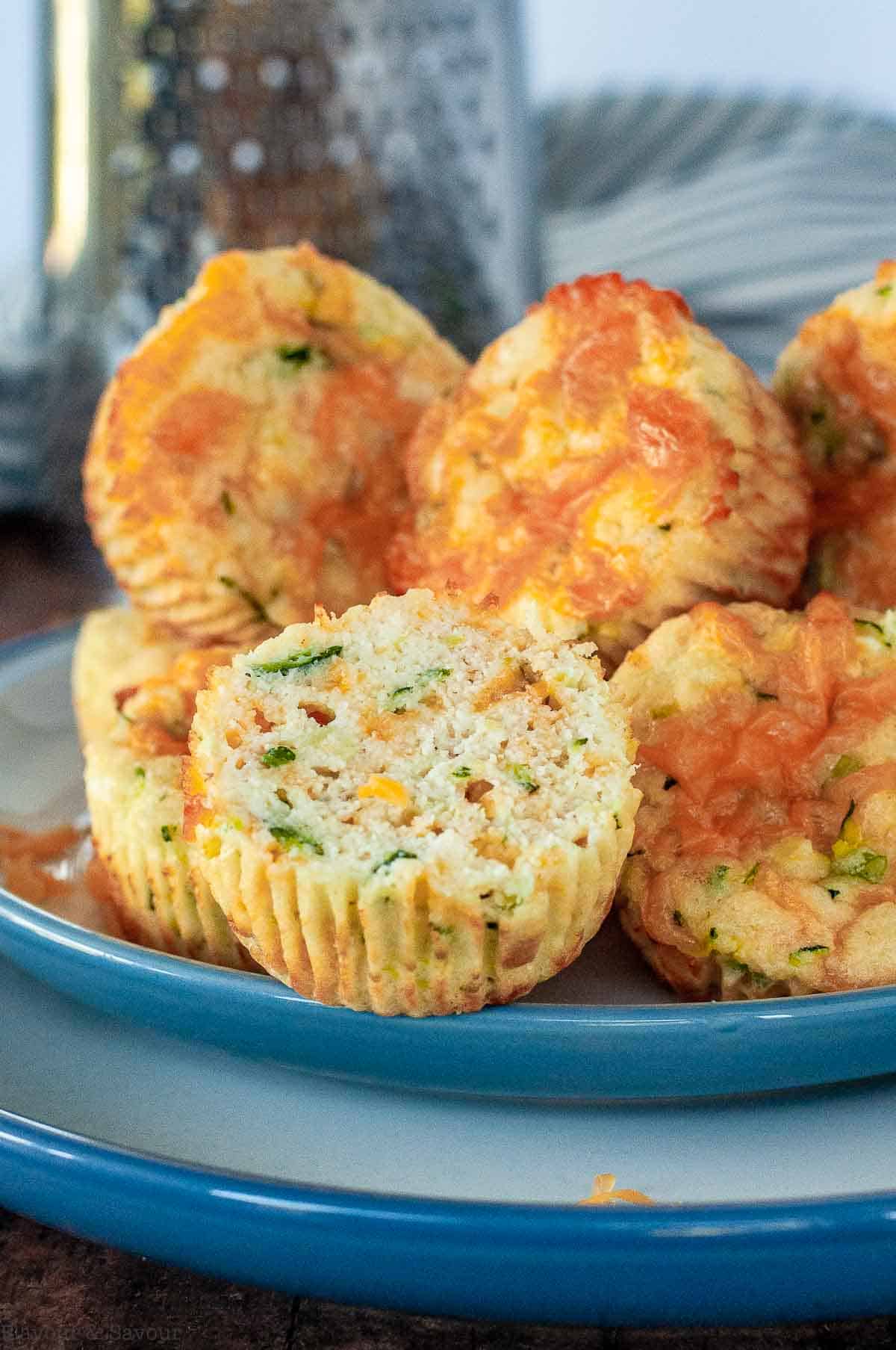 A stack of gluten-free zucchini cheddar muffins on a plate.