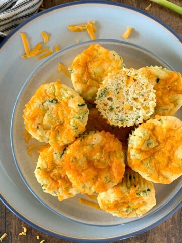 a plate with zucchini cheddar muffins