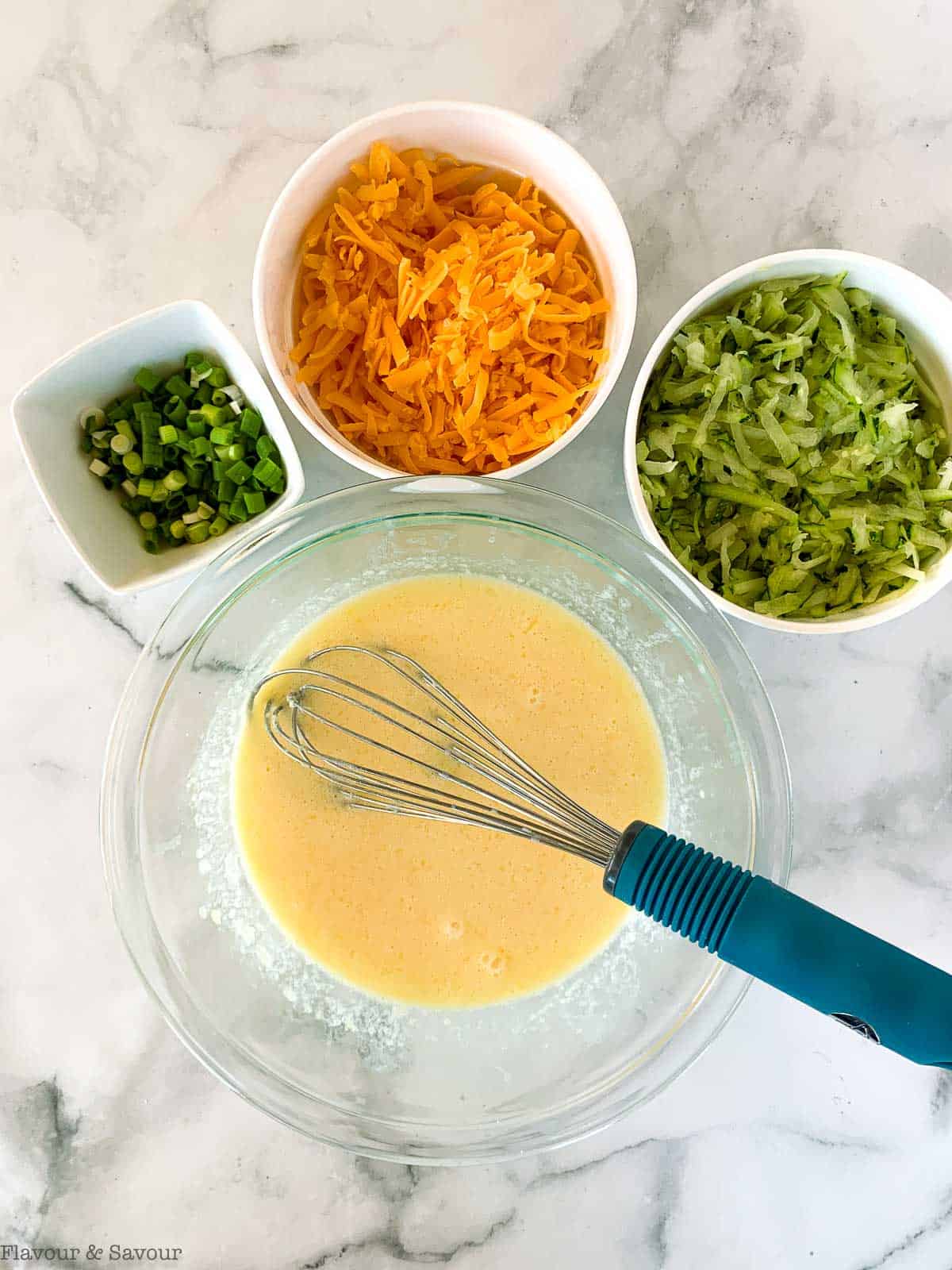 Wet ingredients for zucchini cheddar muffins.