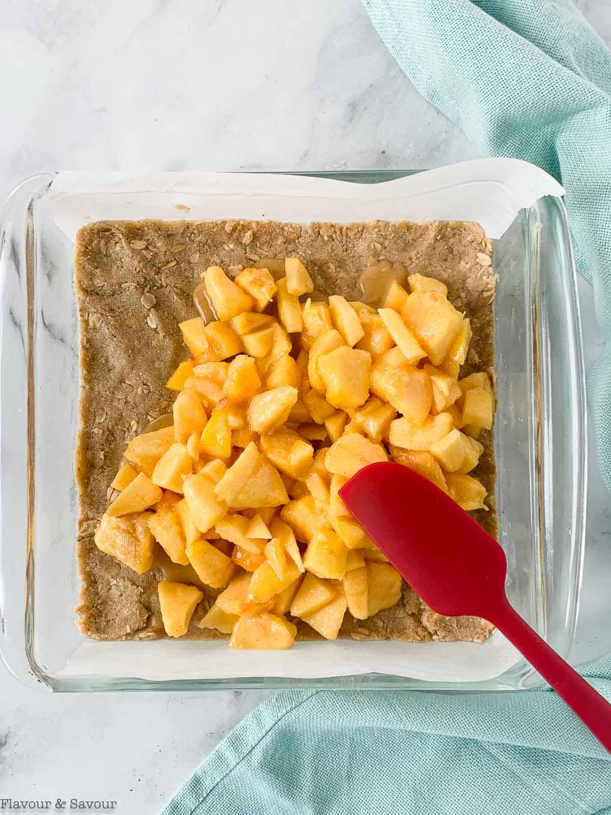 Adding chopped peach mixture to crust.