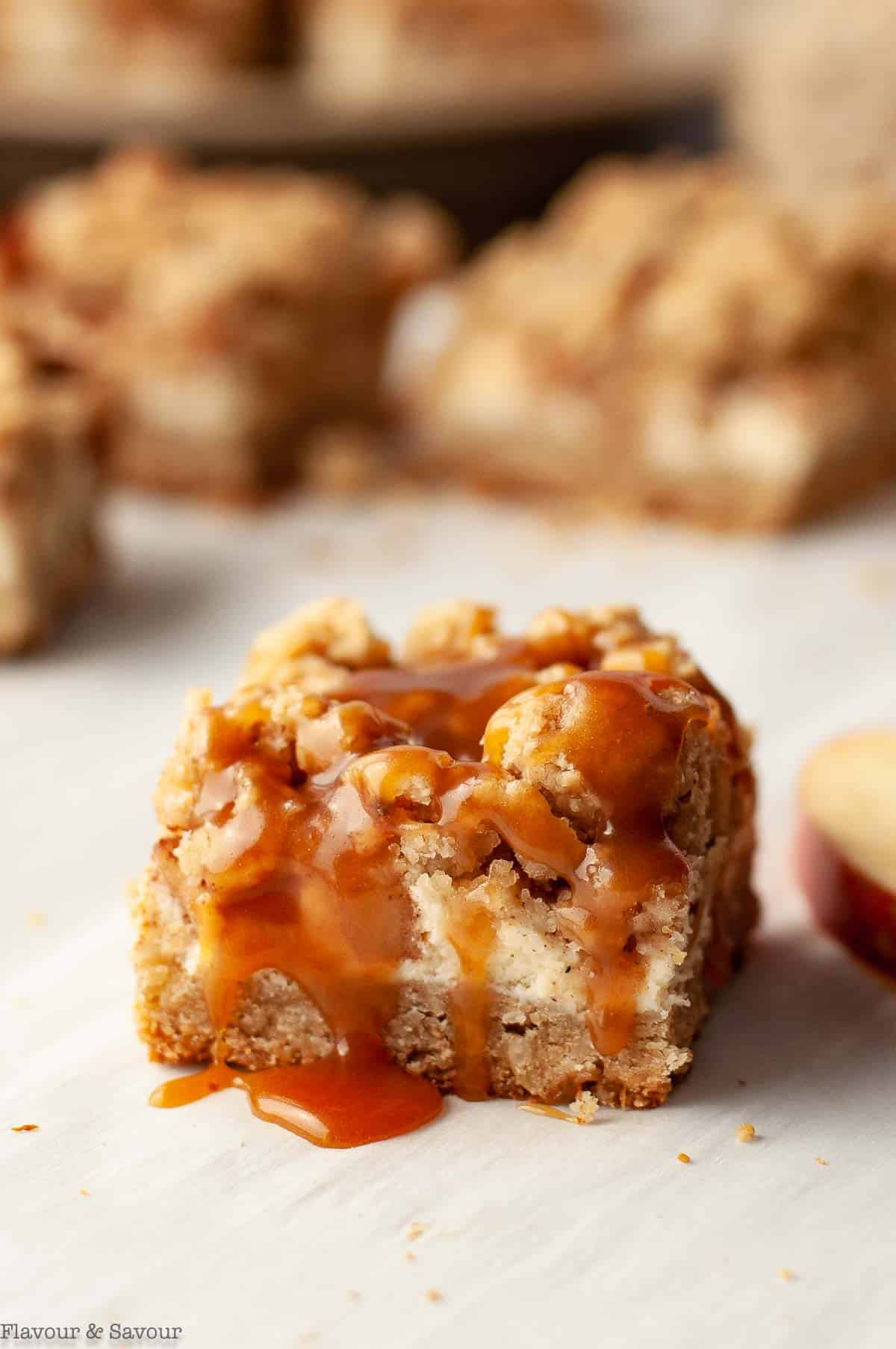 close up view of a single gluten-free apple cheesecake bar