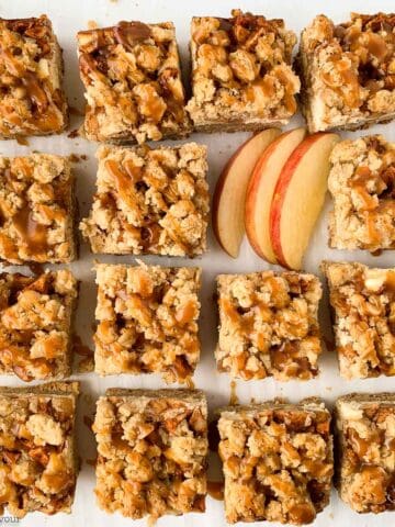 Sliced apple cheesecake crumble bars.