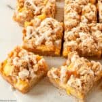 Gluten Free Peach Crumble Bars with vanilla frosting