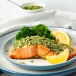 Chimichurri Salmon on a plate with brocoli and lemon