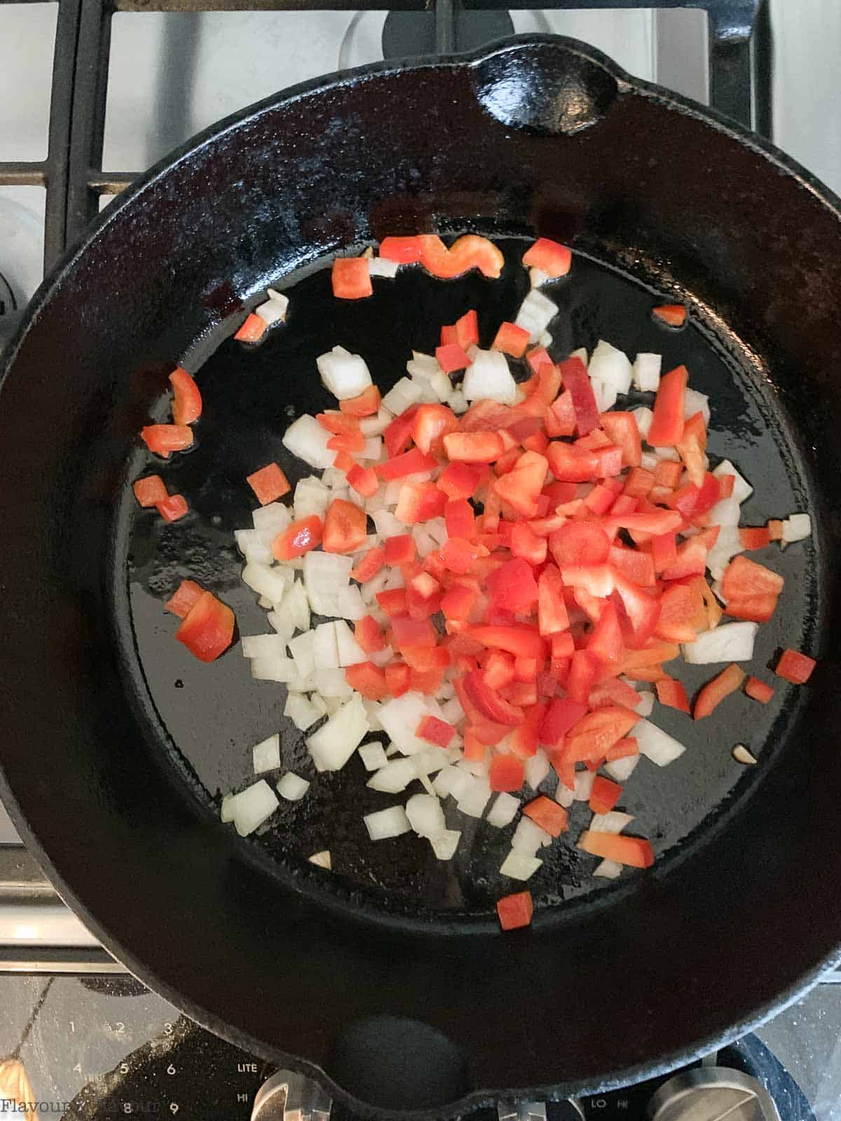 onions and peppers in a cast iron skillet.