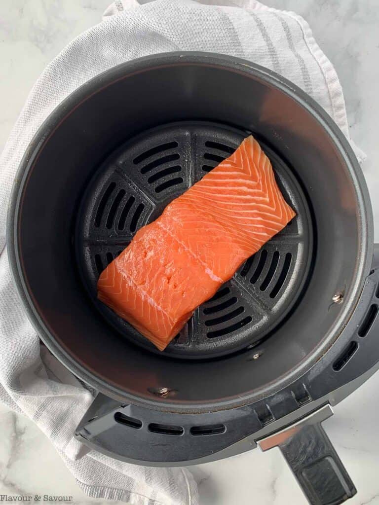 a salmon fillet in a Ninja air fryer basket