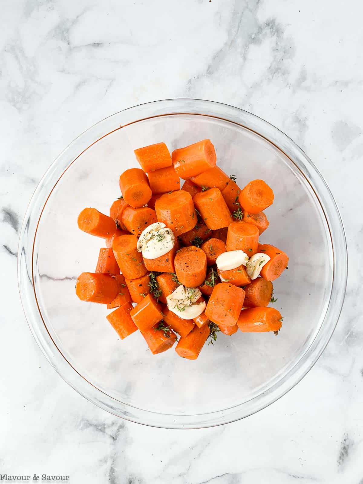 Chopped carrots and garlic in a bowl.