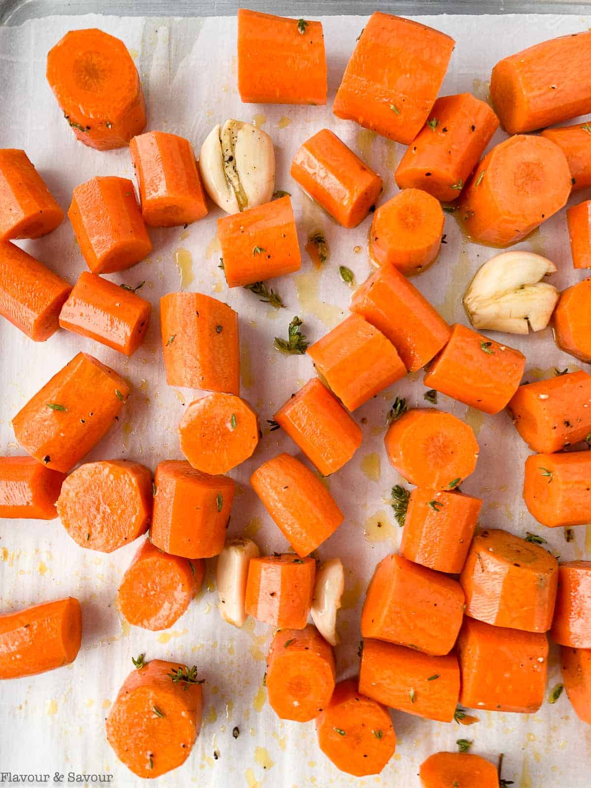 Carrots and garlic on a baking sheet.