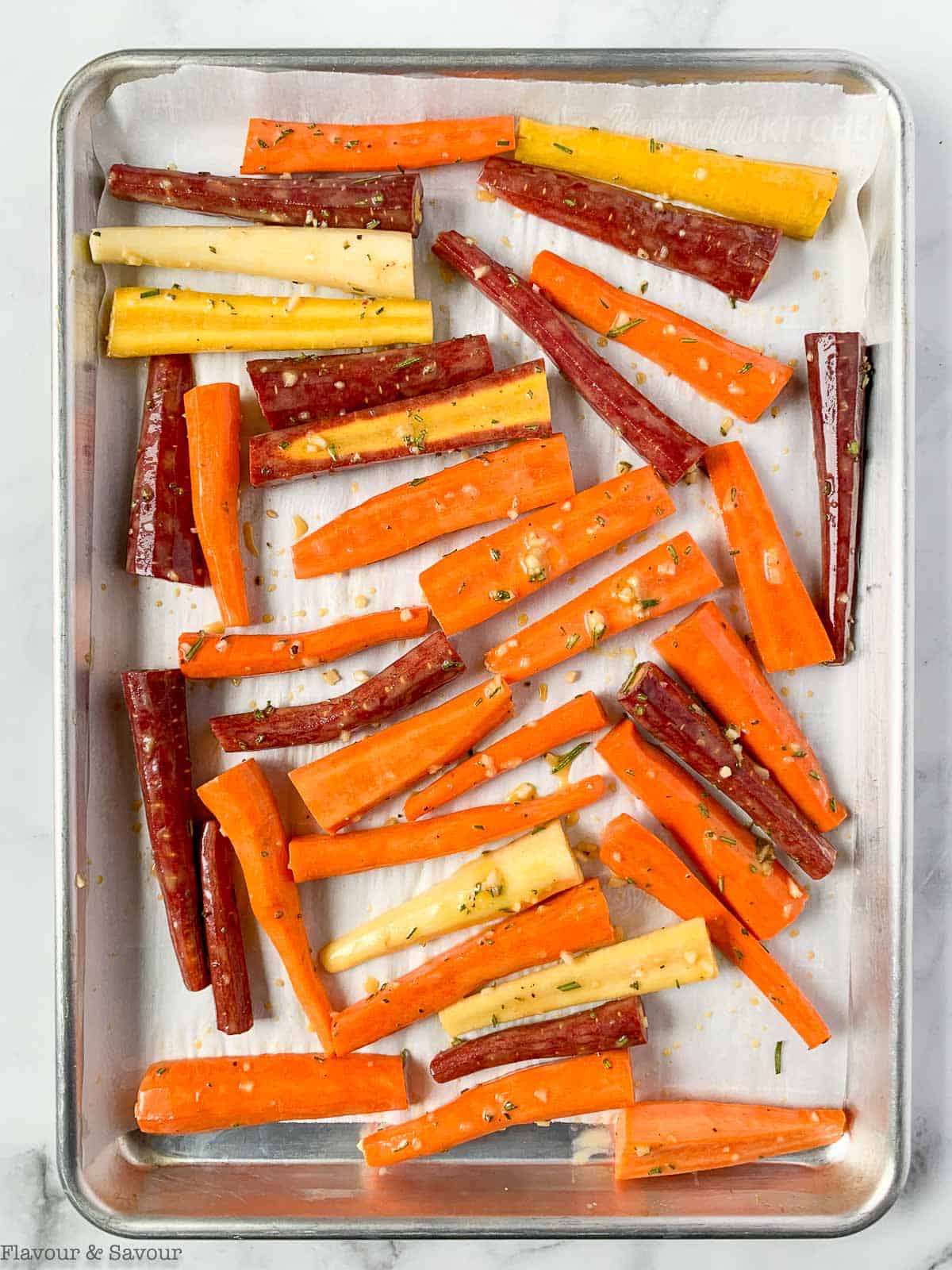 Honey-mustard glazed carrots on a baking sheet.