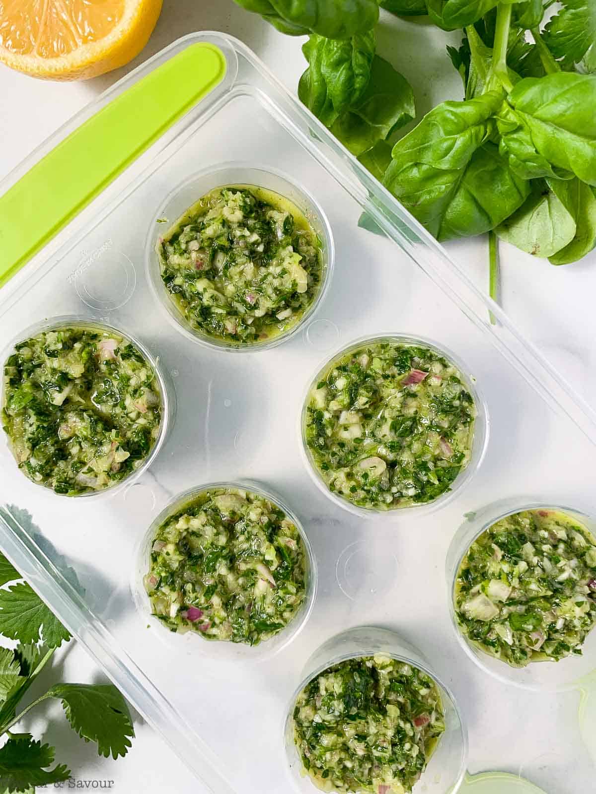Chimichurri sauce in ice cube trays.