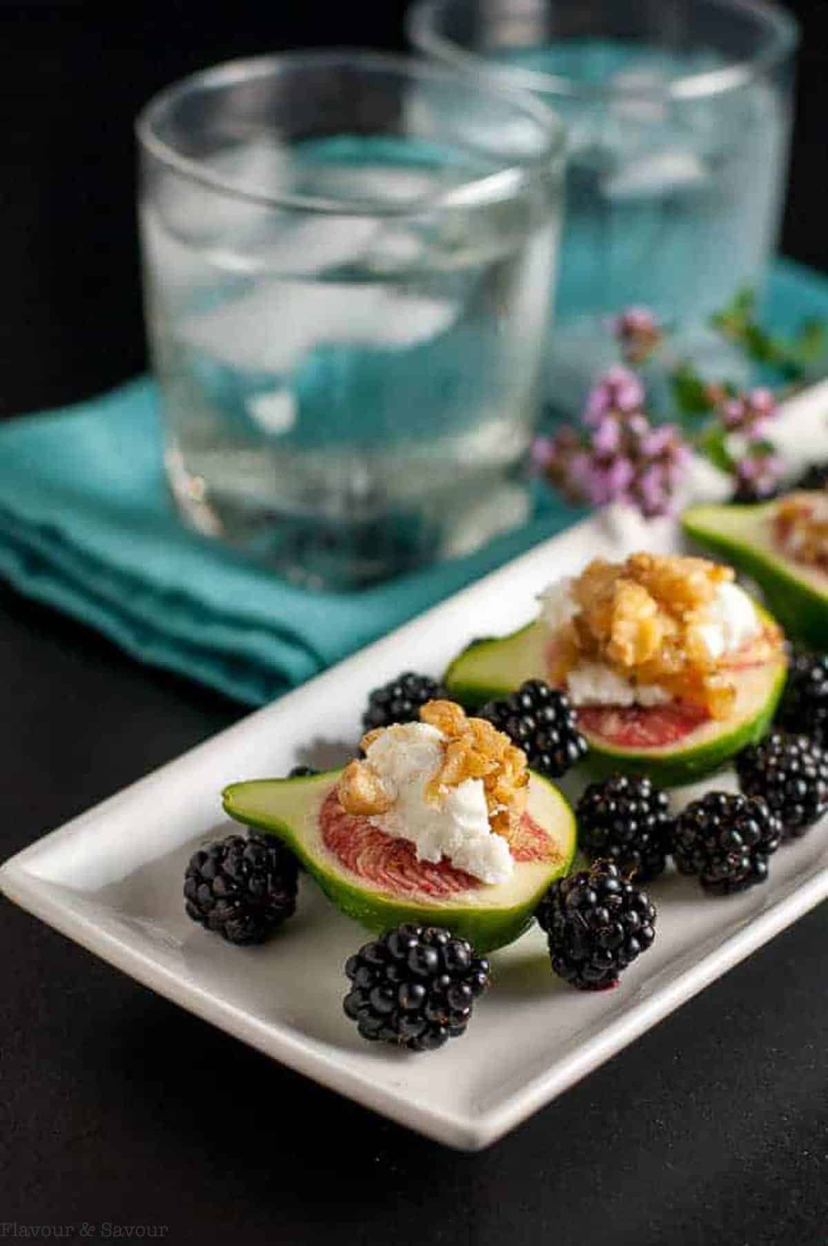 Fresh figs with goat cheese and maple walnuts with blackberries.