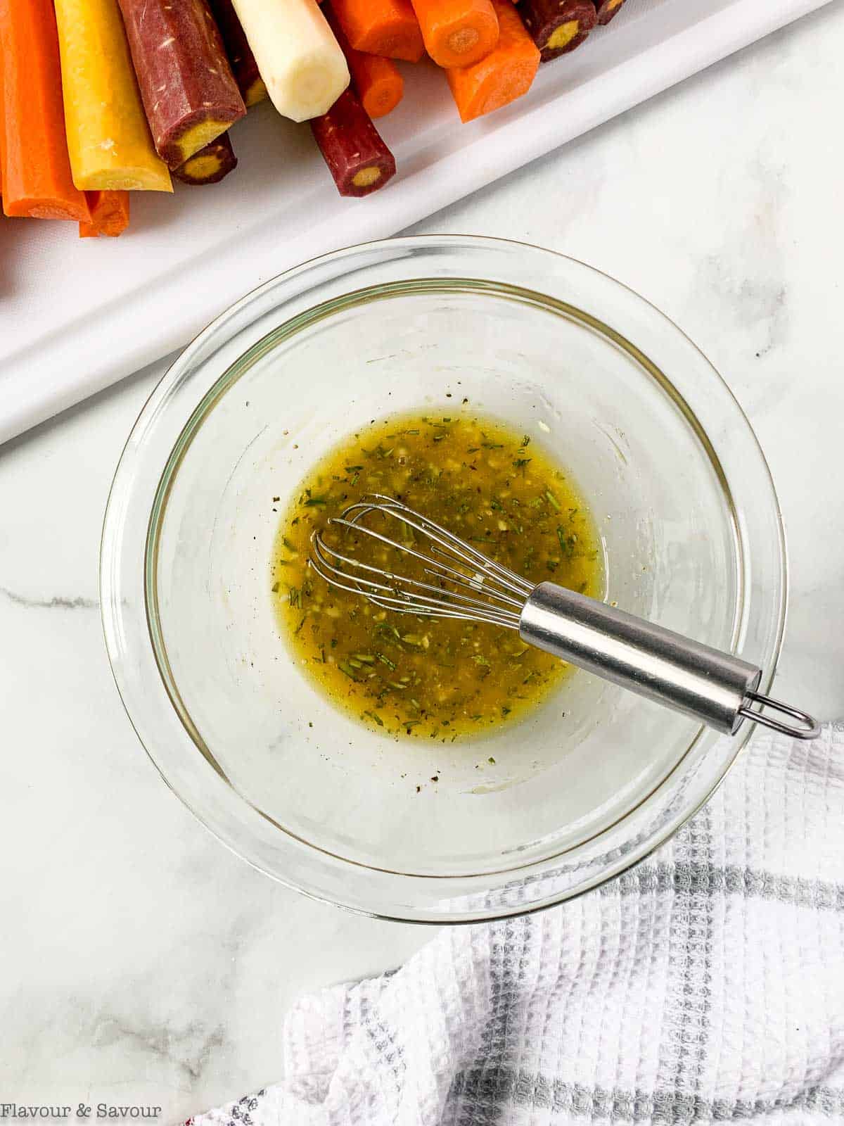 Whisking glaze ingredients for honey-mustard carrots.