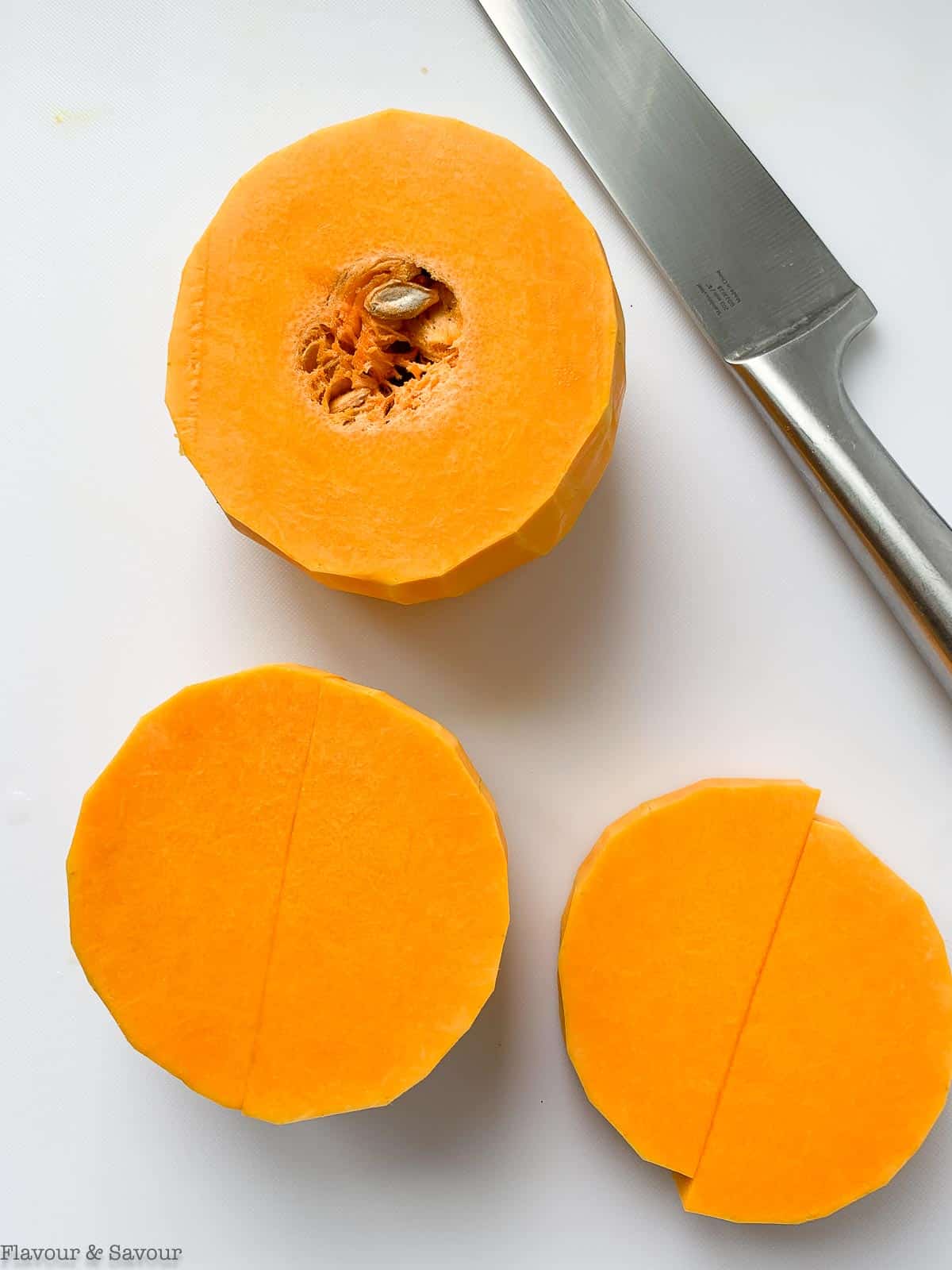 How to cut butternut squash, step 2. Cut through the "neck" to separate the two parts.