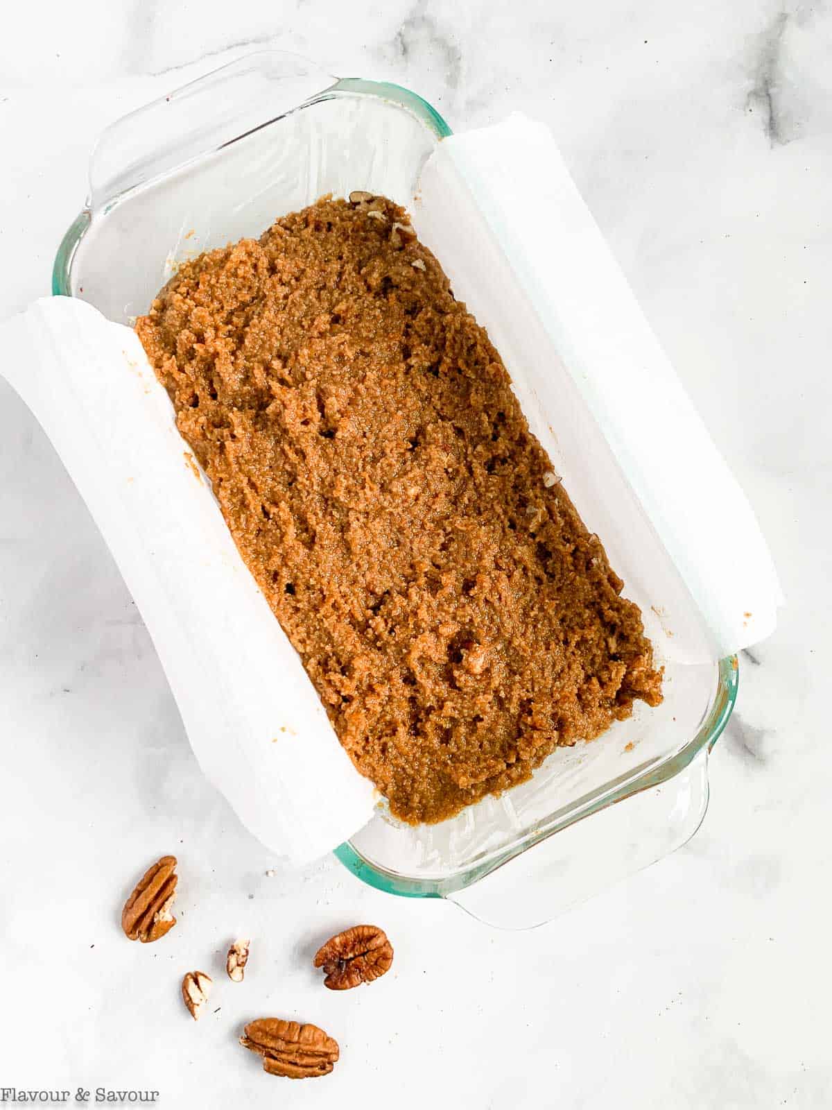 Gluten-free pumpkin loaf batter spread in a loaf pan.