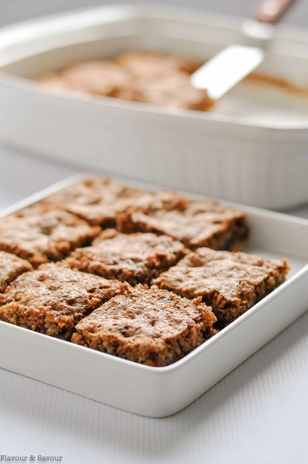 Butter tart squares sliced in a white shallow square dish