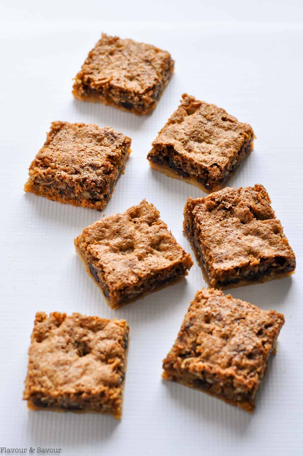 6 gluten-free butter tart squares on a white background