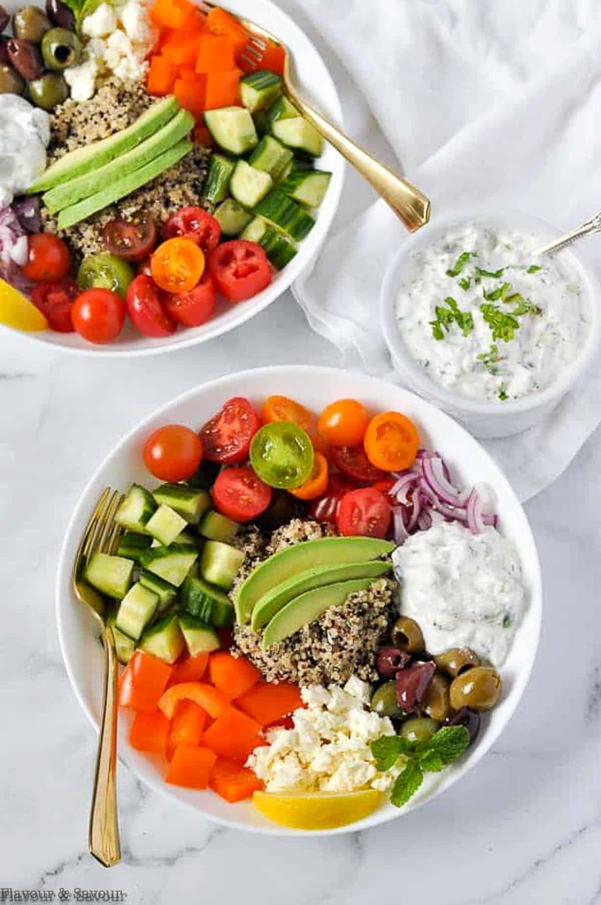overhead view of Mediterranean Quinoa Bowls with a bowl of tzatziki sauce
