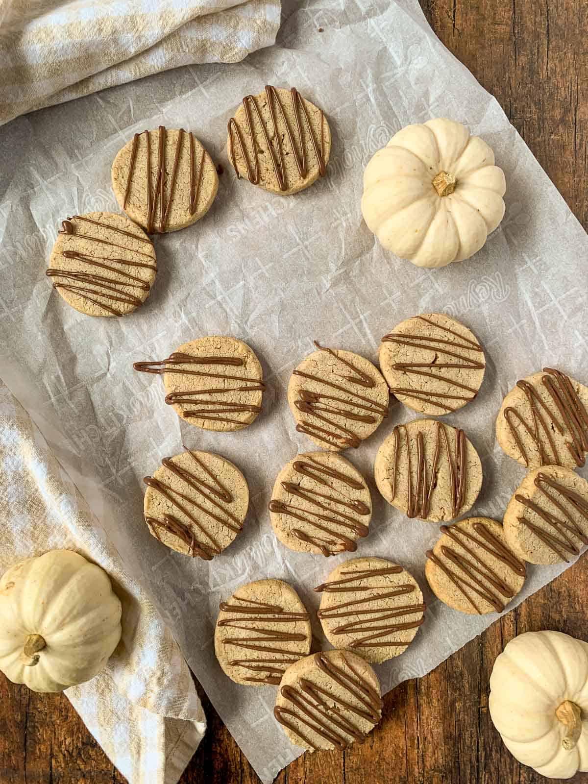 Pumpkin Spice Almond Shortbread Cookies drizzled with milk chocolate.
