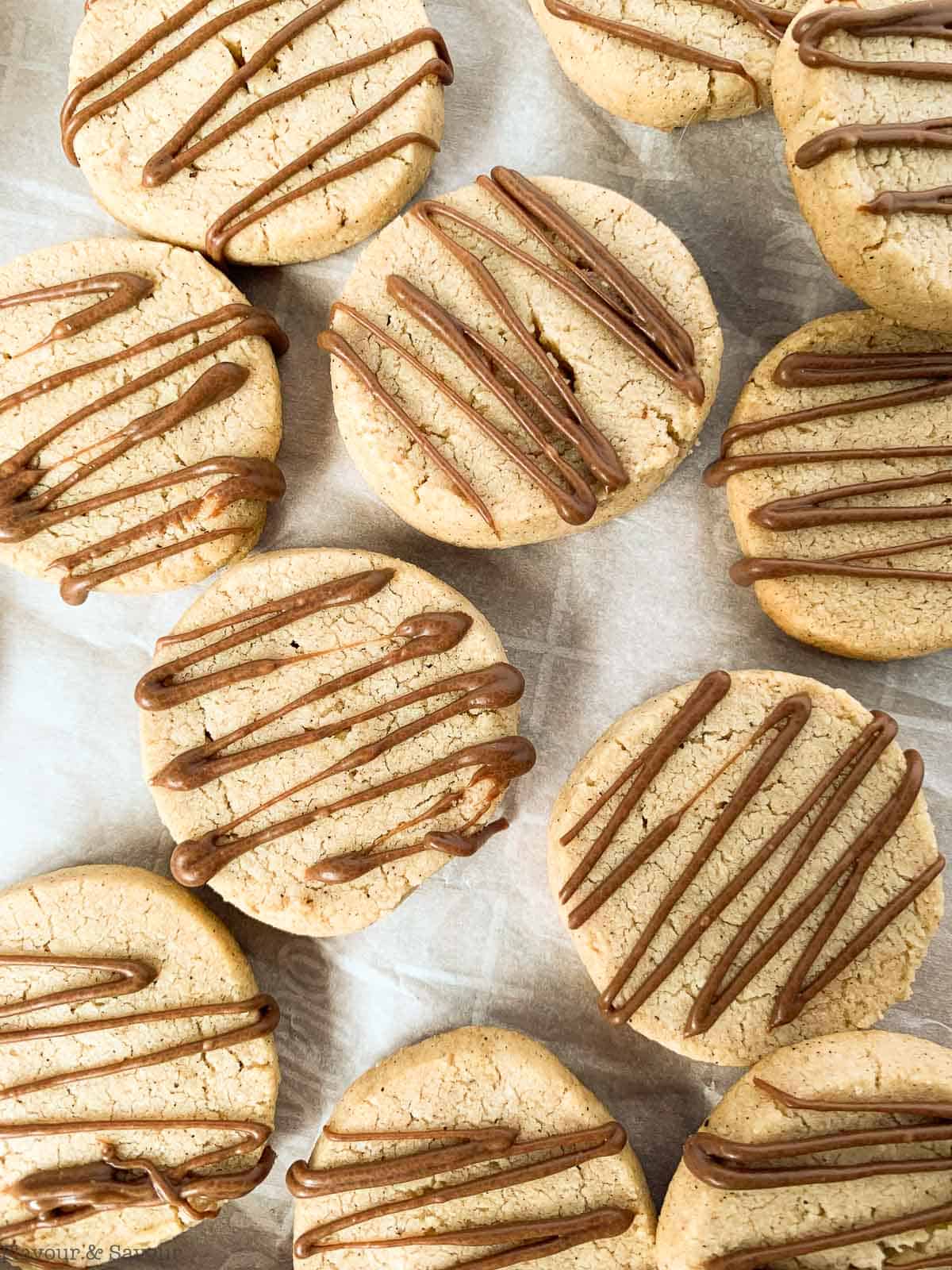 Close up overhead view of pumpkin spice almond shortbread drizzled with milk chocolate