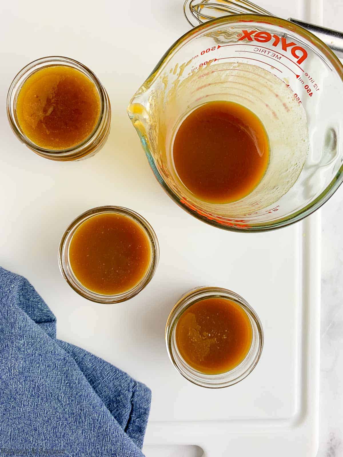 Small mason jars filled with salted caramel sauce.