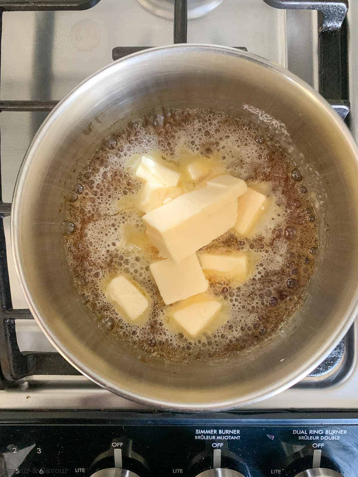 Step 4 for making caramel sauce, add butter and stir.