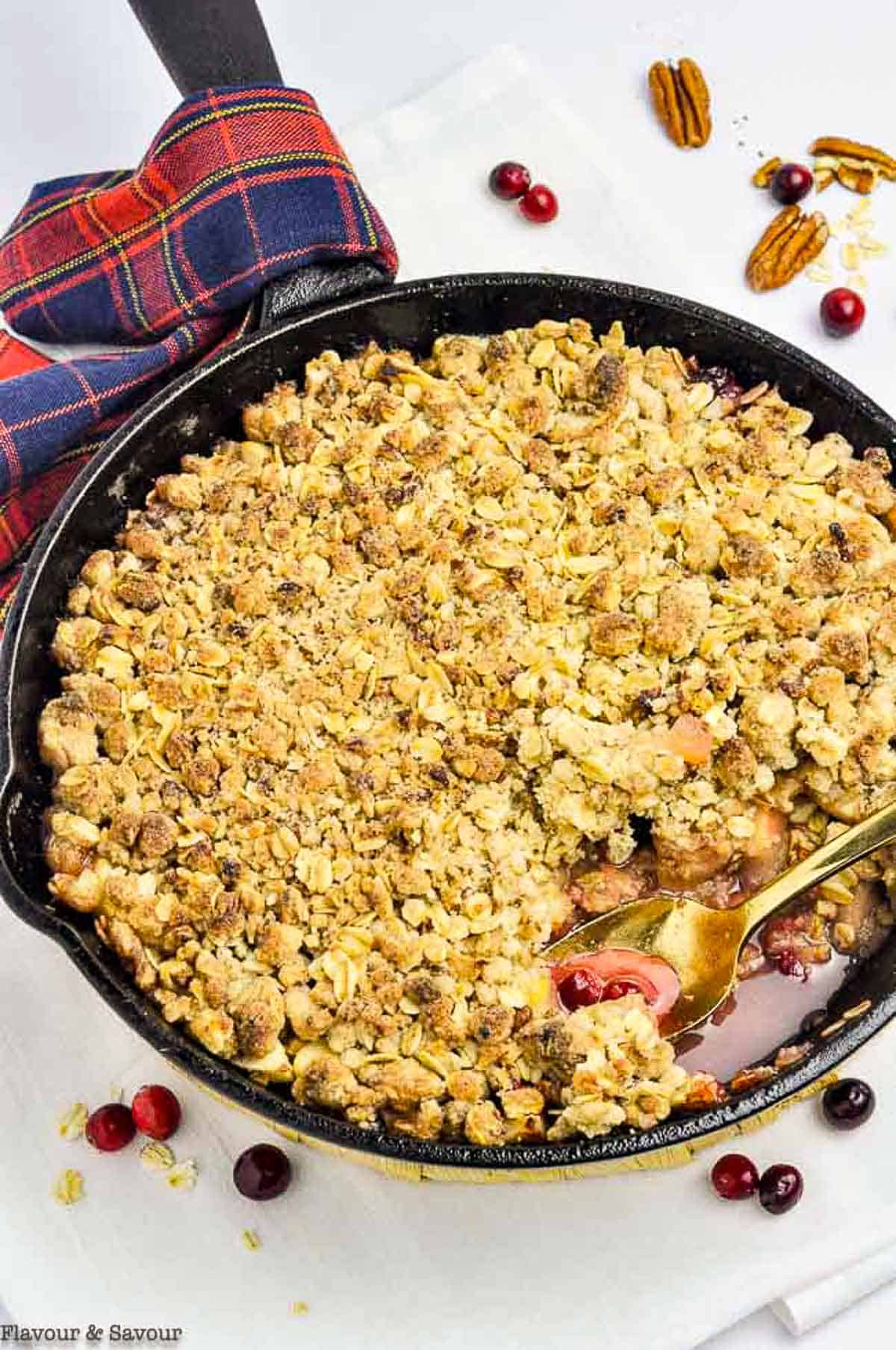 a cast iron skillet with cranberry apple crisp