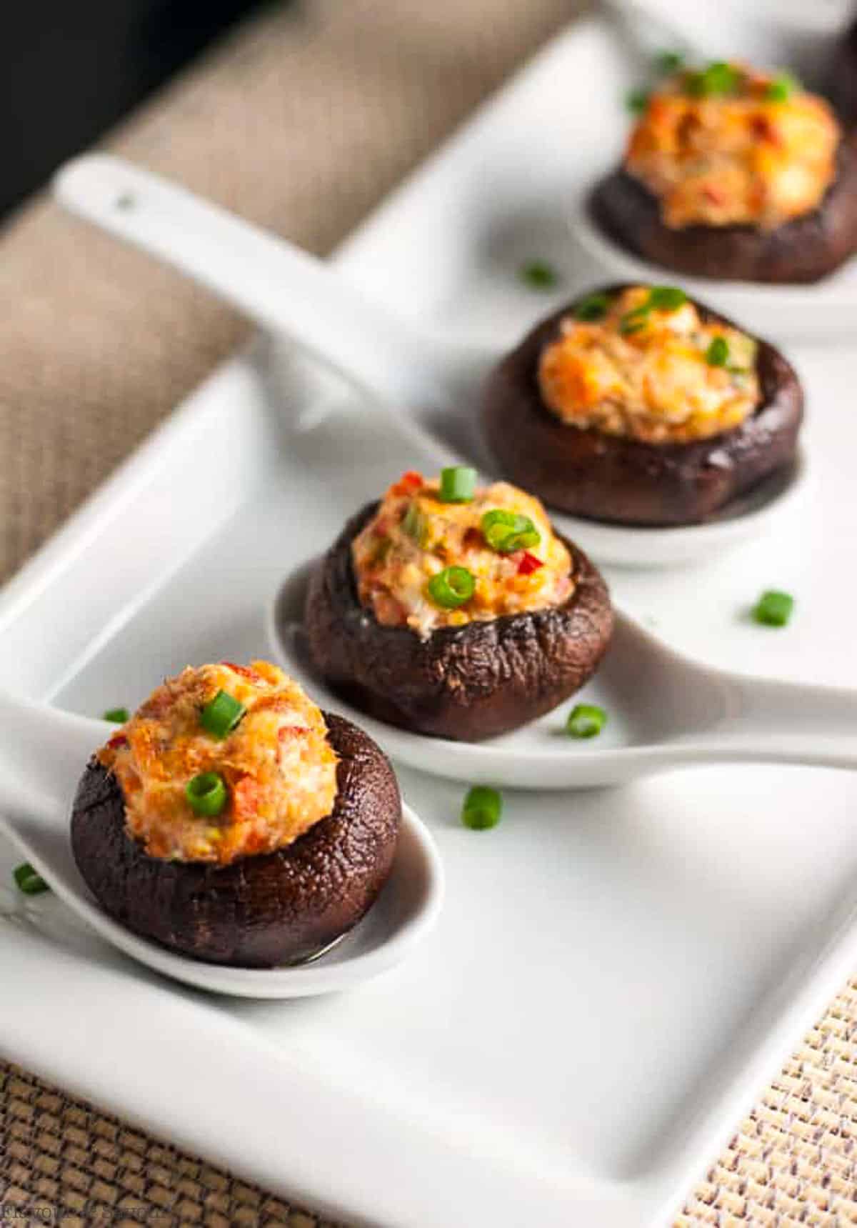 smoked salmon and goat cheese stuffed mushrooms in ceramic spoons