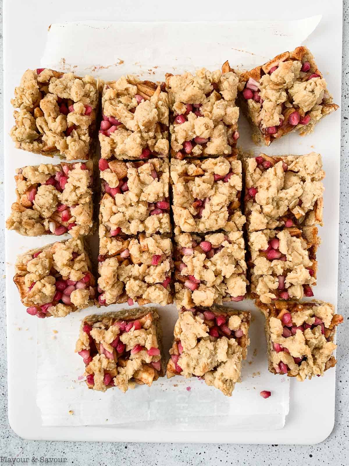 Apple Pomegranate Crumble Bars on a cutting board