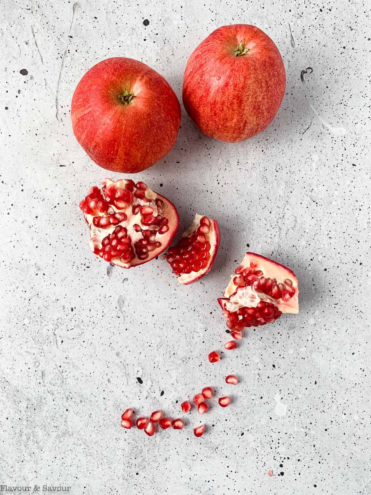 apples and an opened pomegranate as ingredients for Apple Pomegranate Crumble Bars