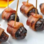 bacon-wrapped stuffed dates on toothpicks