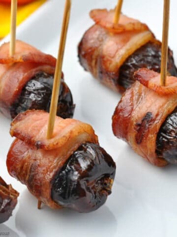 bacon-wrapped stuffed dates on toothpicks