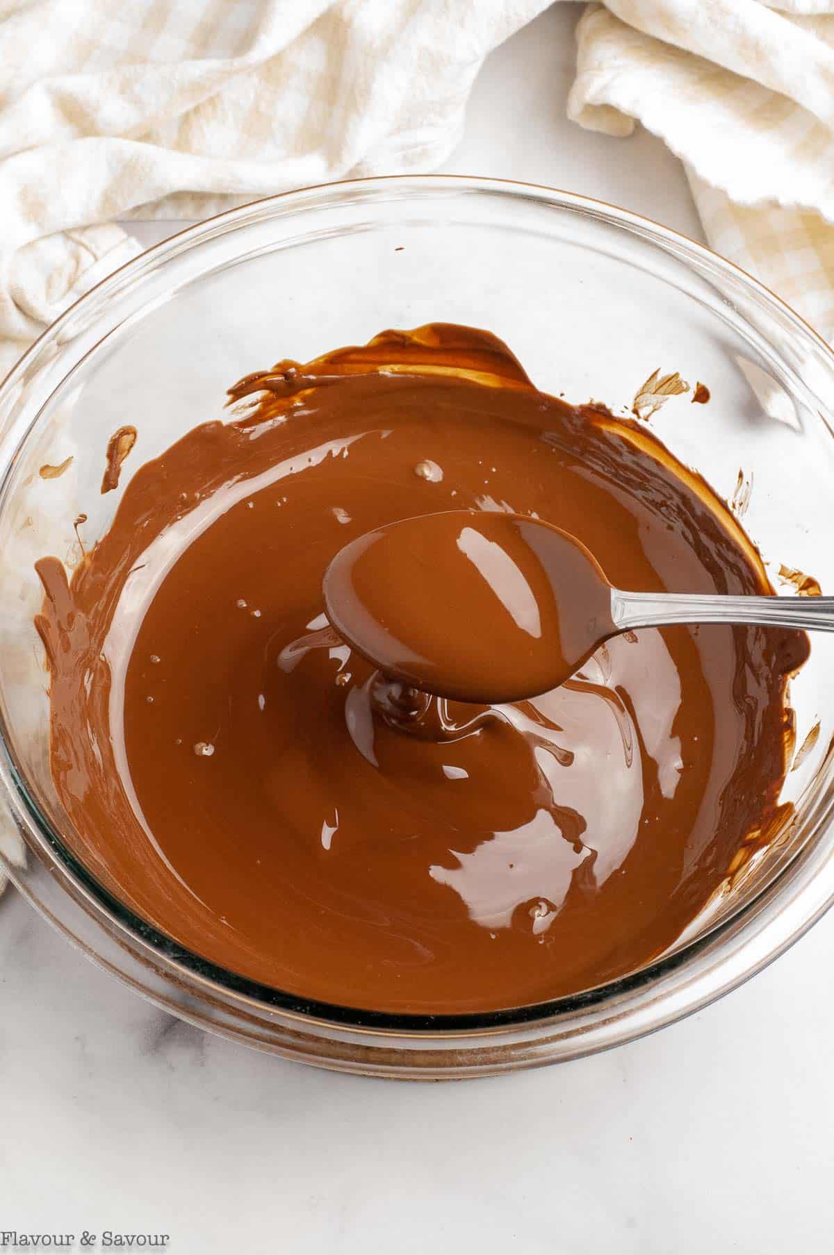Melted chocolate in a glass bowl.
