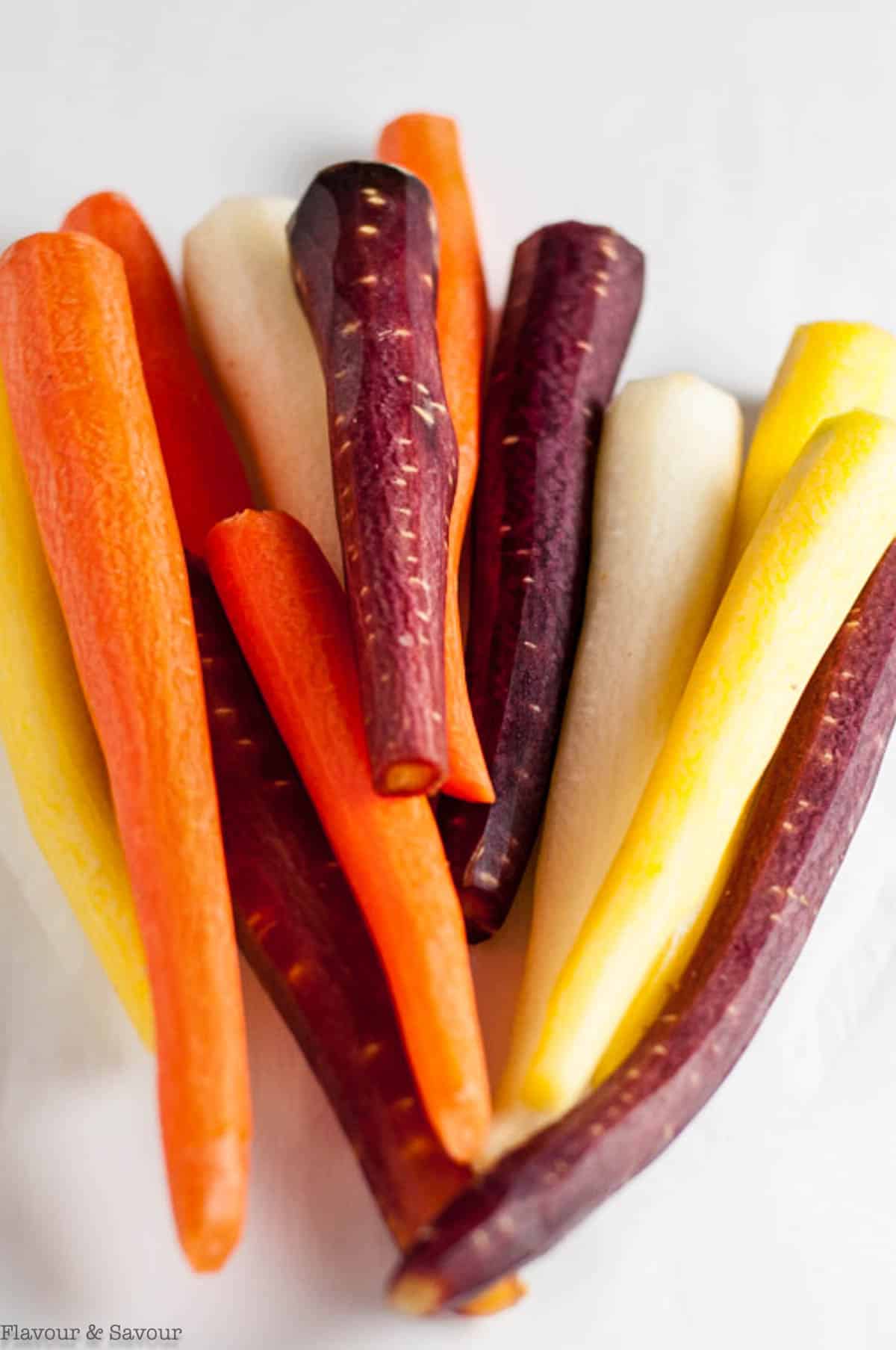 Raw rainbow carrots with tops removed.