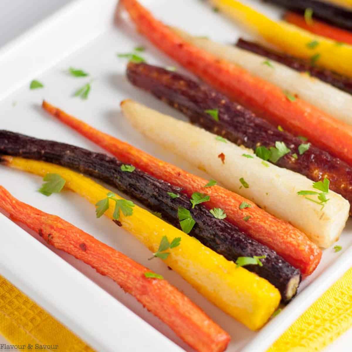 Roasted rainbow carrots sprinkled with parsley.