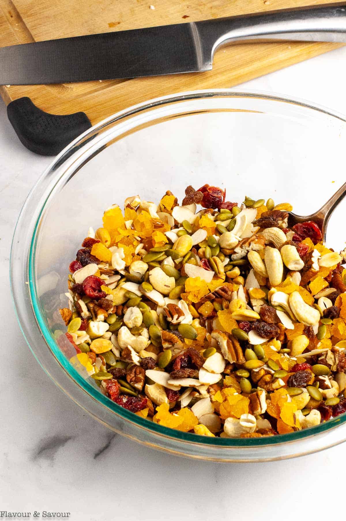 A bowl of nuts, seeds and dried fruit to make trail mix.