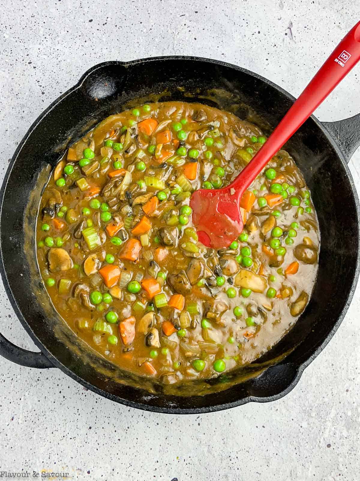 Vegetarian shepherd's pot pie filling in a cast iron skillet.