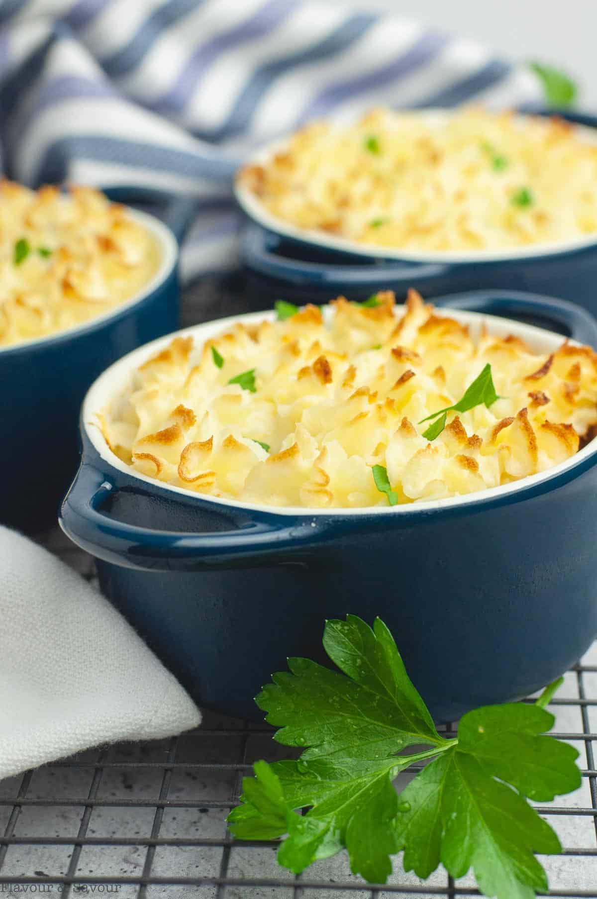 3 small casserole dishes with personal shepherd's pies.