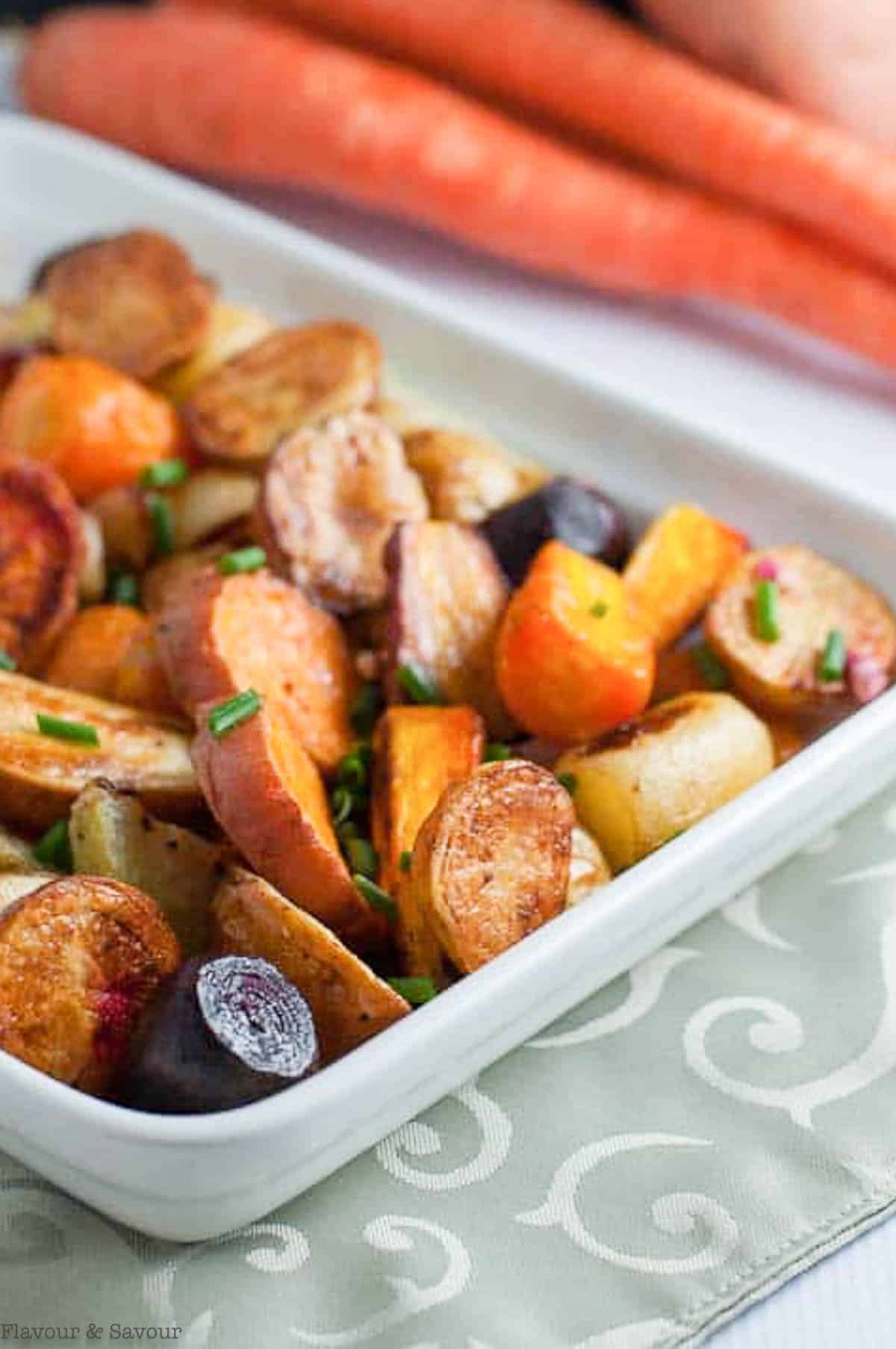 apple cider roasted root vegetables with whole carrots in the background.