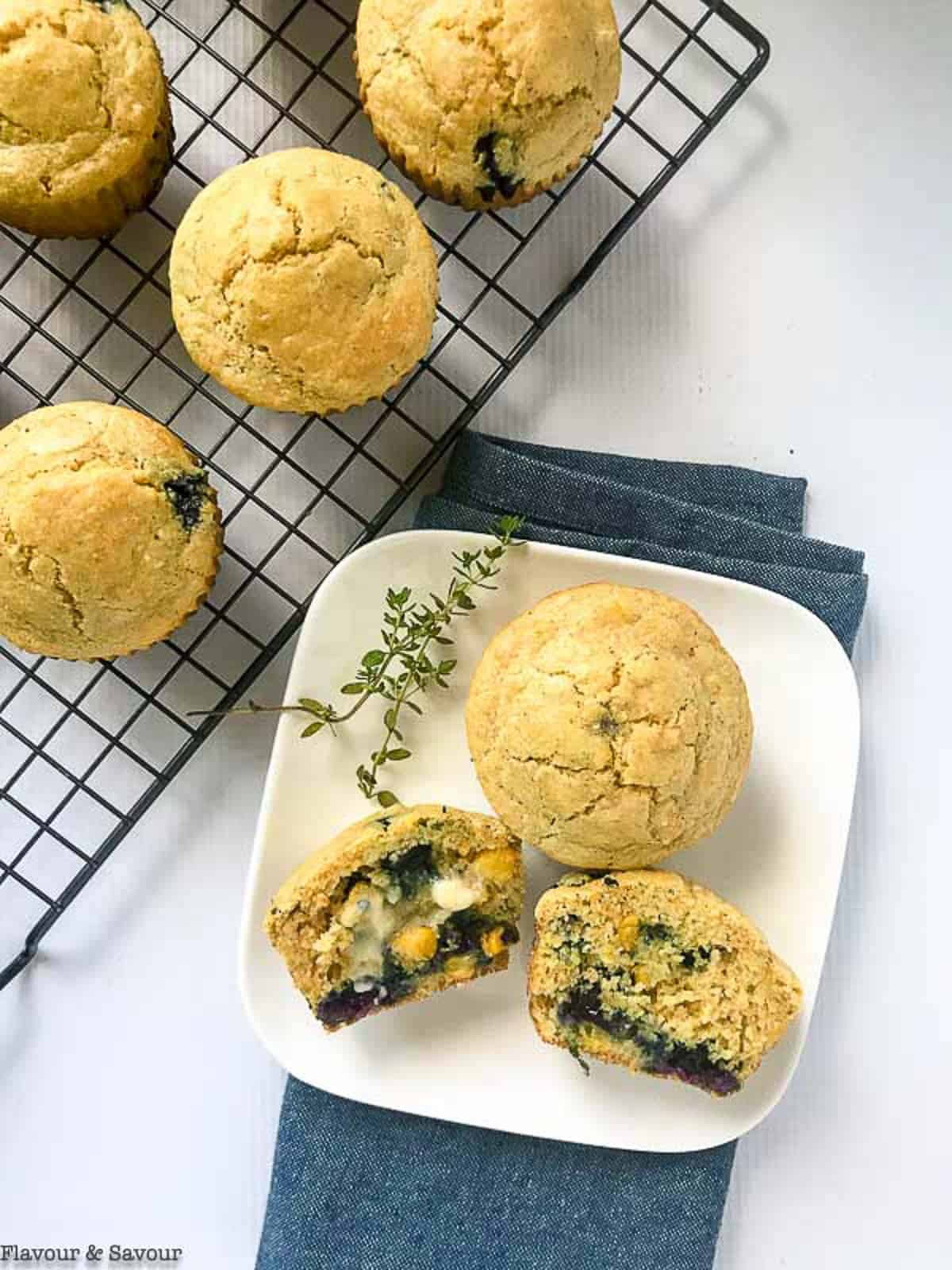 overhead view of blueberry cornbread muffins on a plate with melted butter