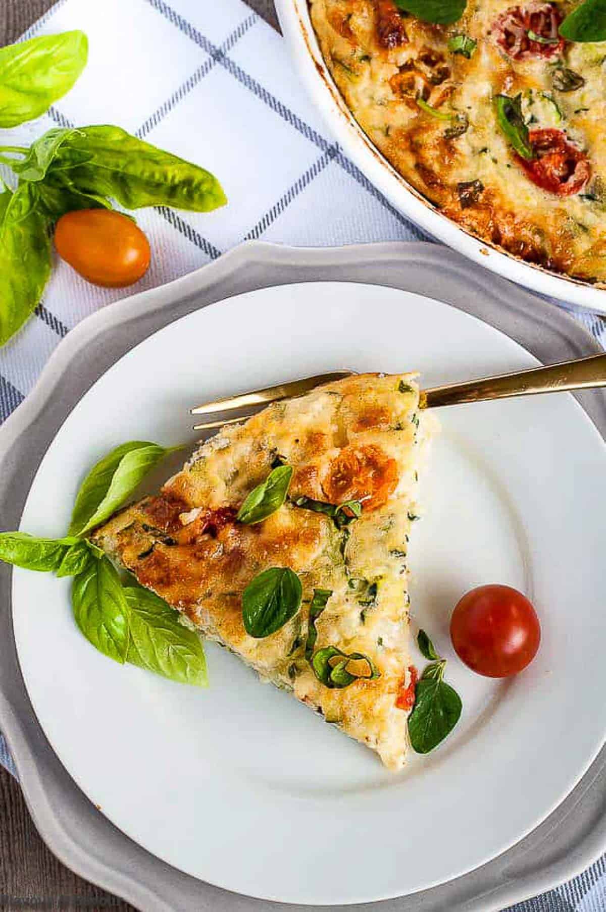 a slice of cheesy zucchini quiche on a plate