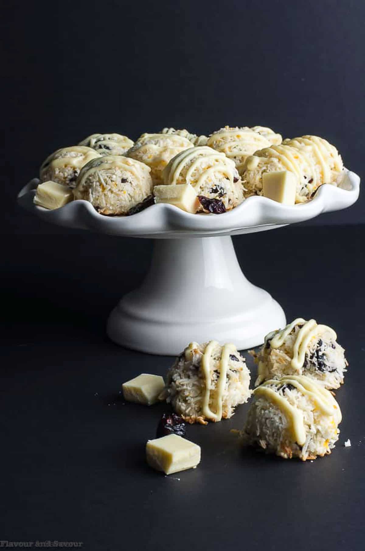 cranberry white chocolate macaroons on a white pedestal cake plate