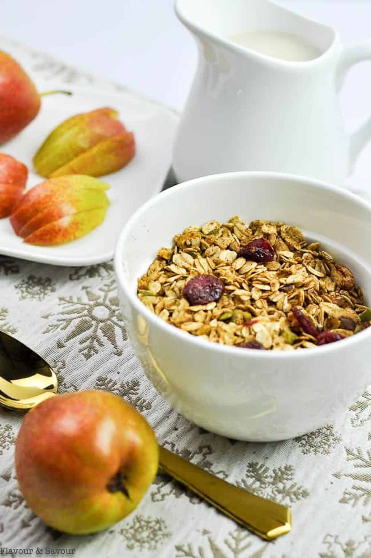 Homemade gingerbread granola in a bowl with fresh sliced pears.