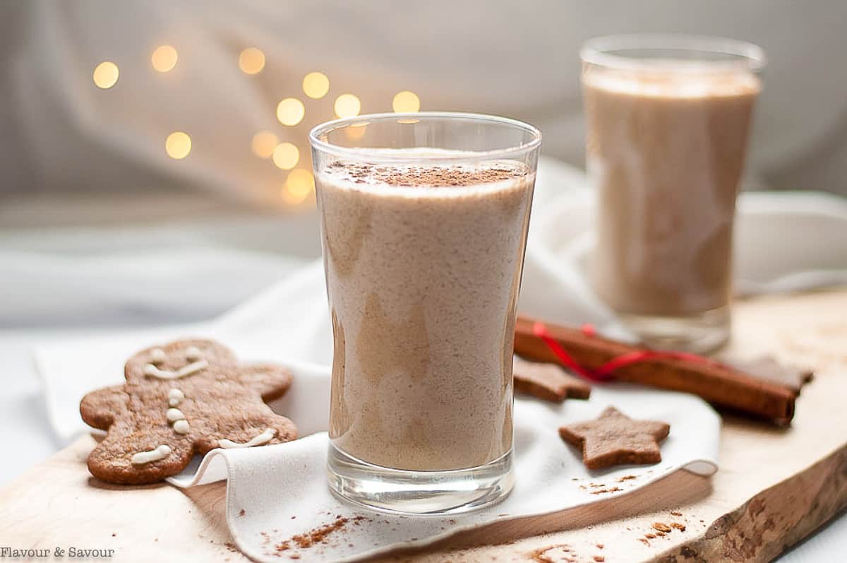 two glasses of gingerbread smoothie with a decorated gingerbread man