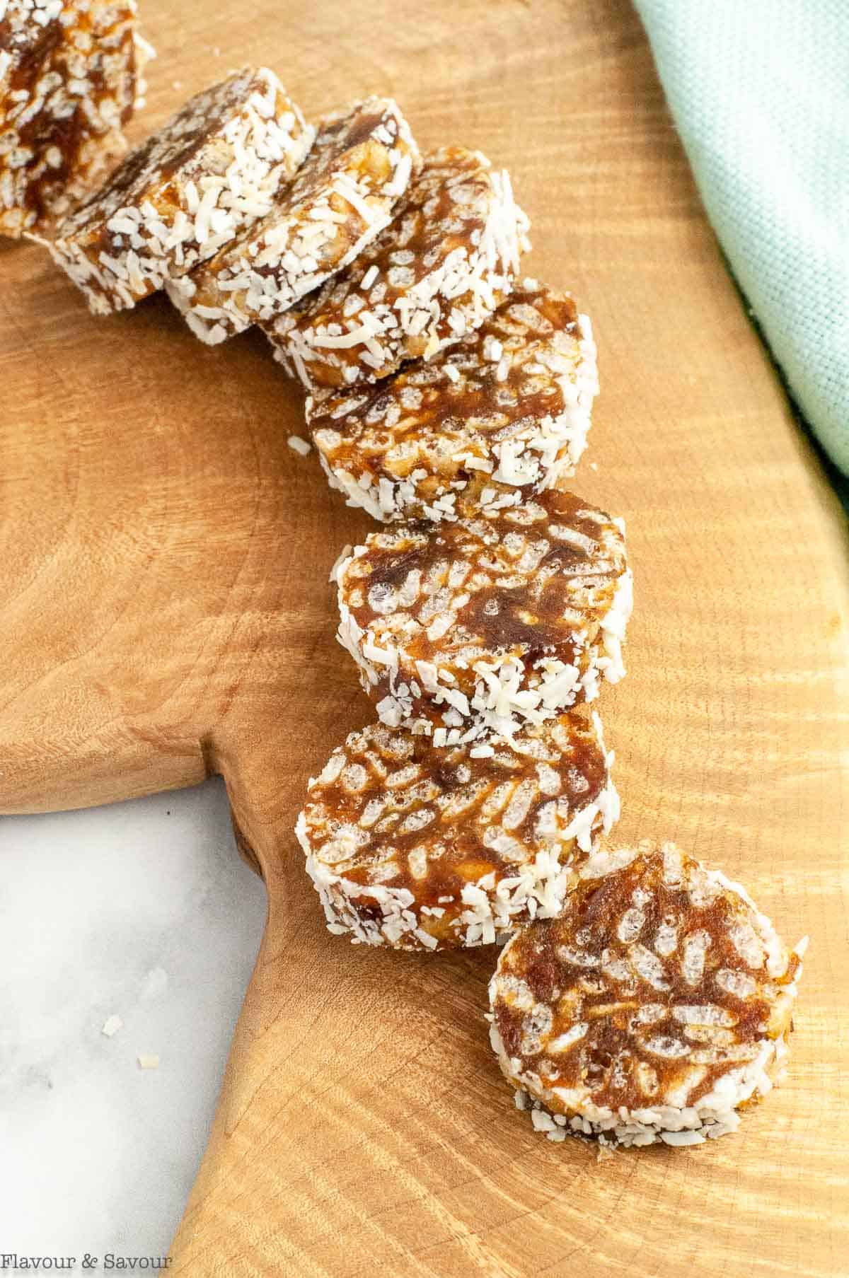 Slices of coconut date logs on a serving board