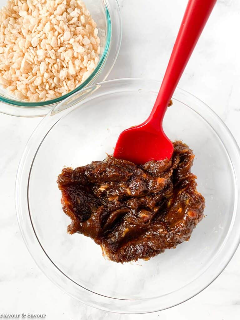 Date paste cooling in a glass bowl.