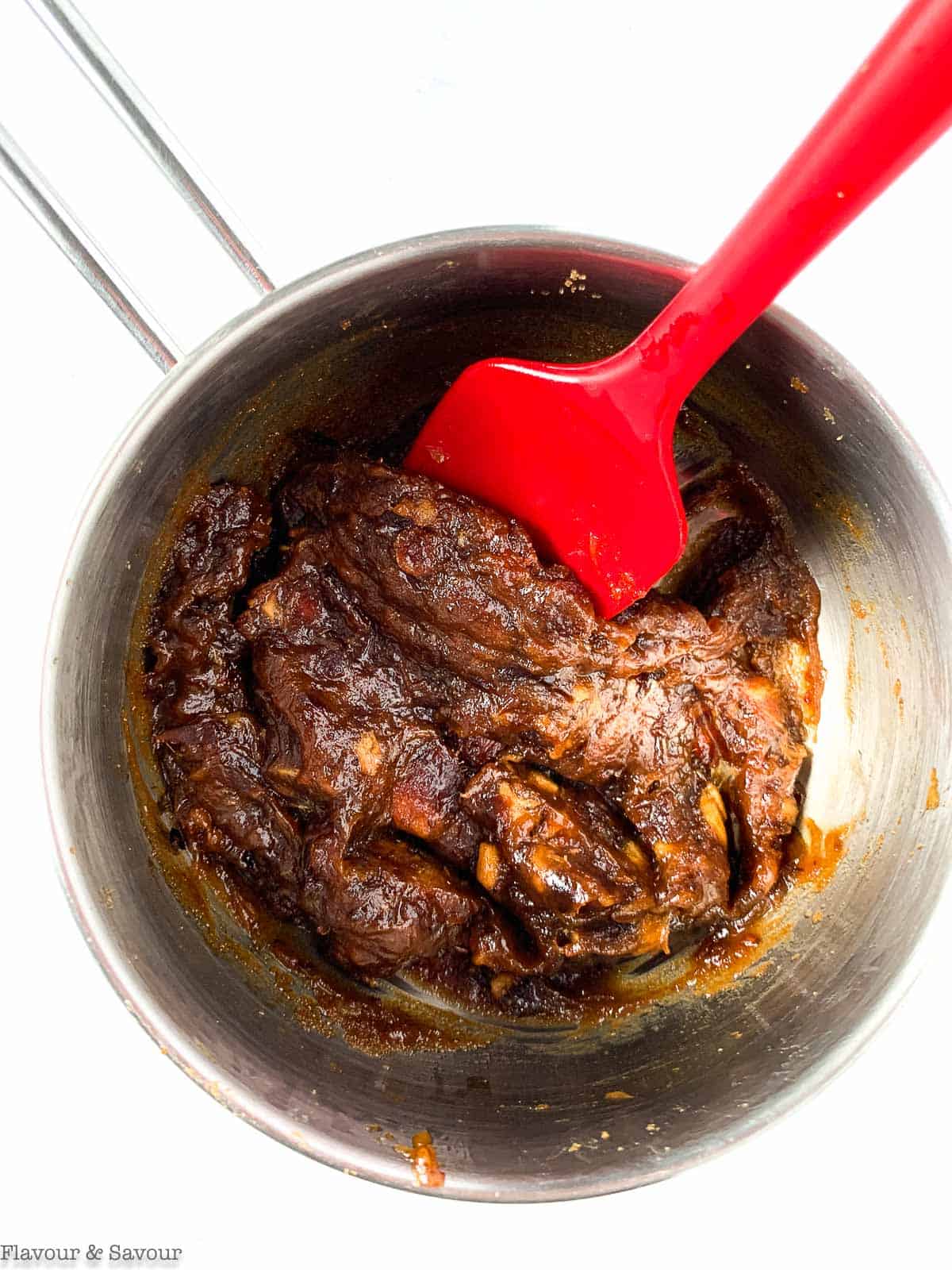 Thick date paste in a saucepan.